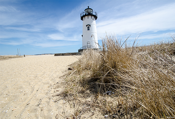 Lighthouse in midday on a beach